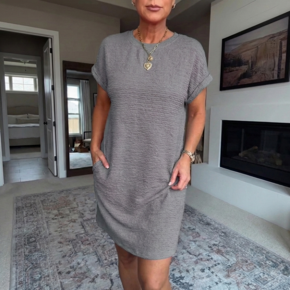 Women's textured short dress with crew neckline, short sleeves and side pockets