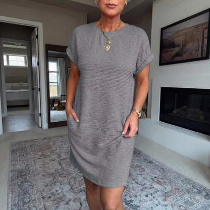 Women's textured short dress with crew neckline, short sleeves and side pockets