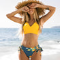 Women's two-piece swimsuit with ruched V-neck top and tie-side bikini bottoms