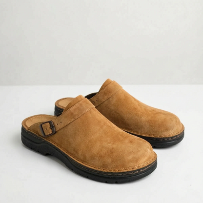 Men's closed-toe mule shoes with buckle straps and raised black soles
