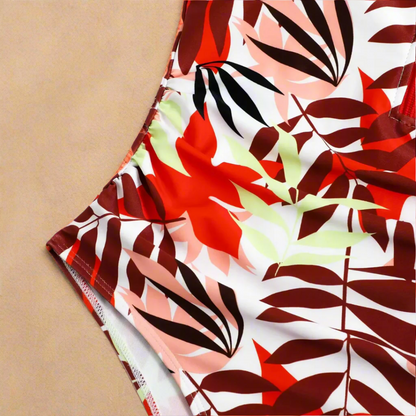 Women's short-sleeve one-piece swimsuit with front zip and leafy print