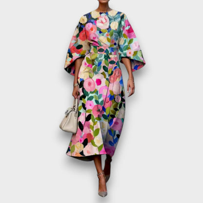 Women's floral midi dress with round neckline and flowing cape sleeves