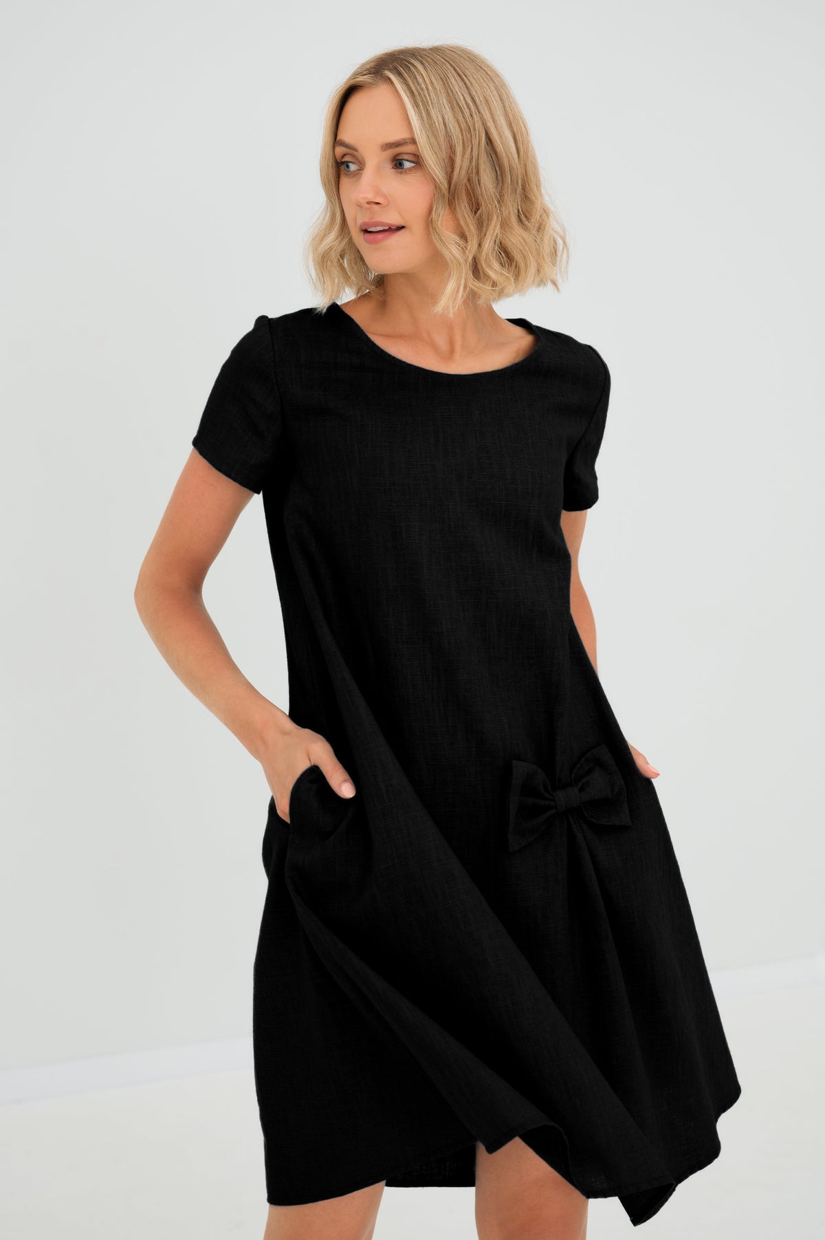 Women's A-line short dress with round neckline, short sleeves, bow detail and front pockets