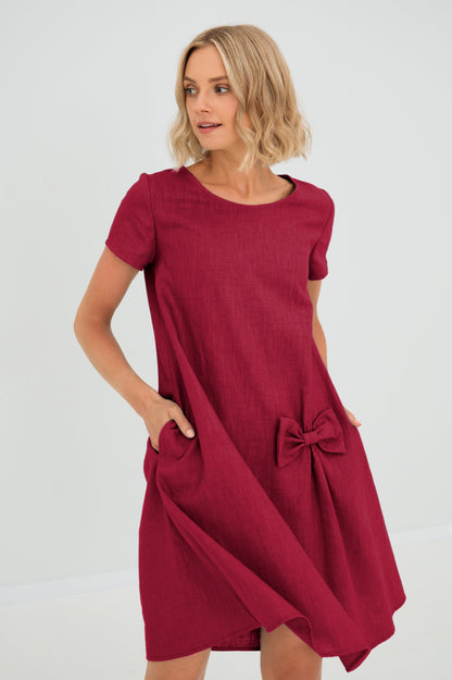 Women's A-line short dress with round neckline, short sleeves, bow detail and front pockets