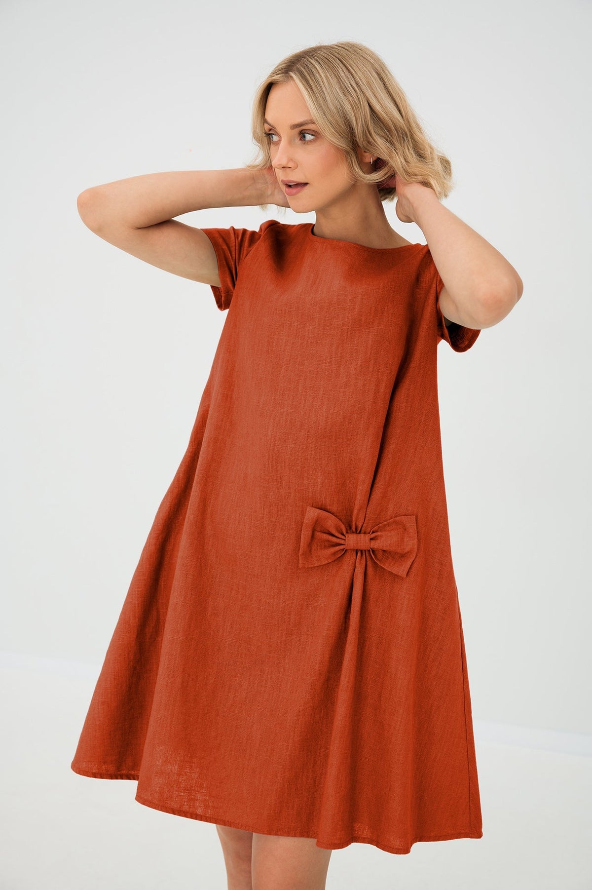 Women's A-line short dress with round neckline, short sleeves, bow detail and front pockets