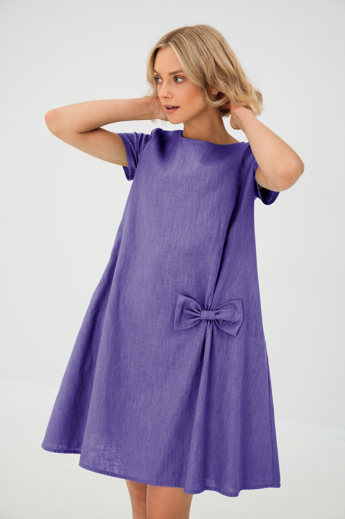 Women's A-line short dress with round neckline, short sleeves, bow detail and front pockets