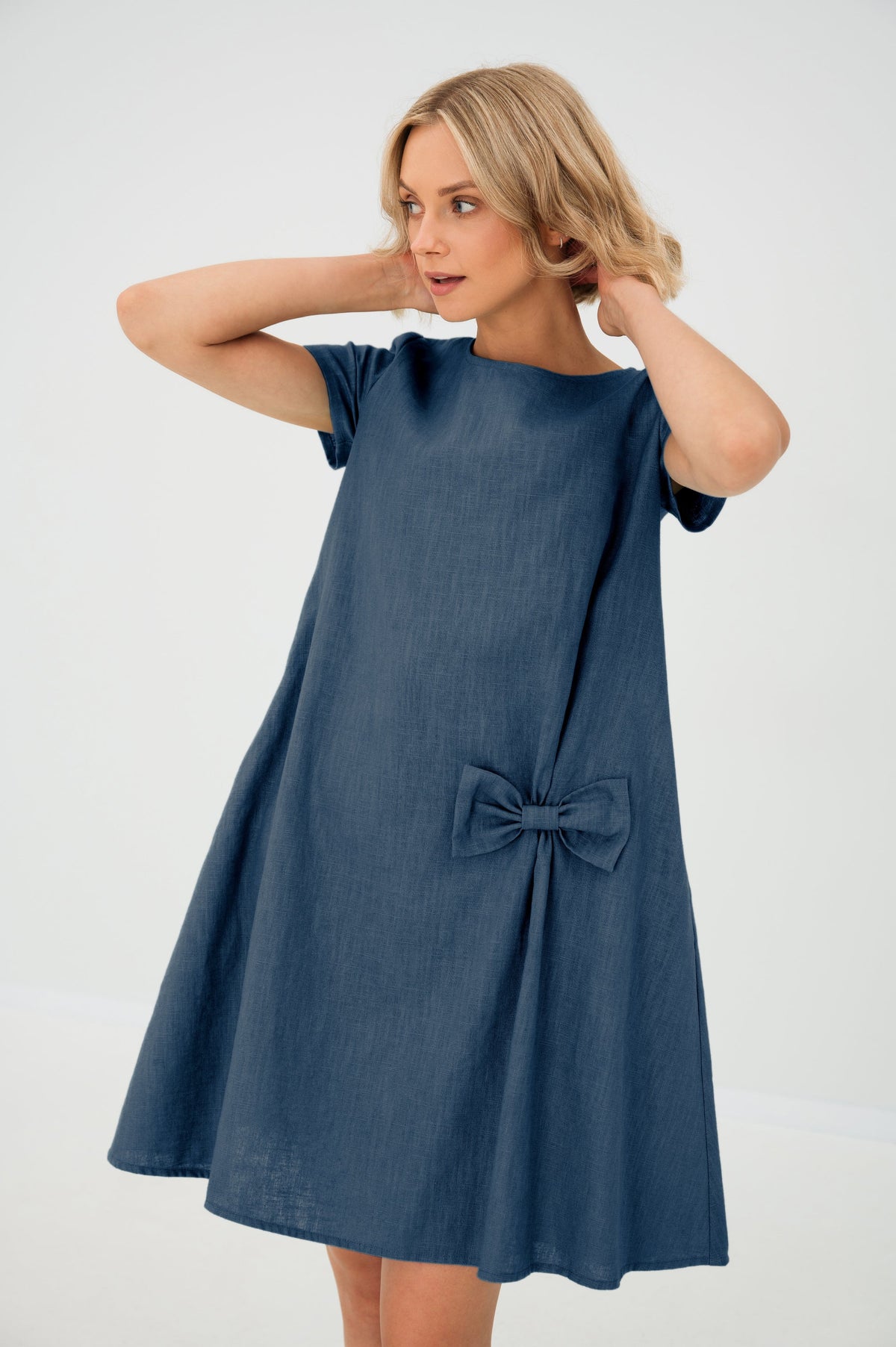 Women's A-line short dress with round neckline, short sleeves, bow detail and front pockets