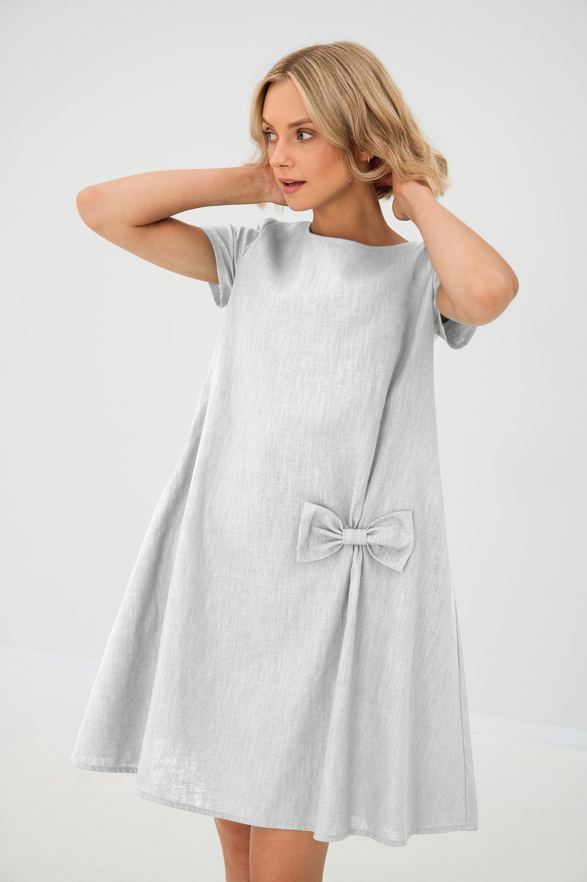 Women's A-line short dress with round neckline, short sleeves, bow detail and front pockets