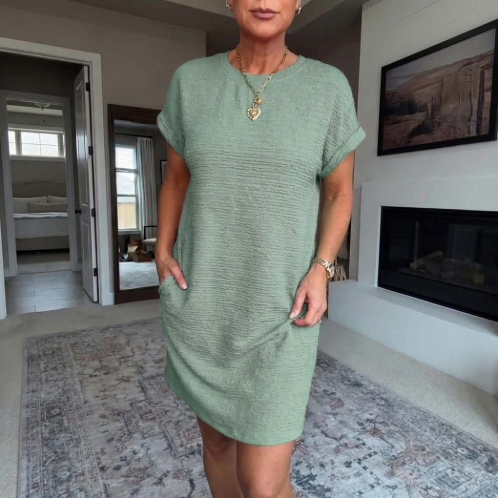 Women's textured short dress with crew neckline, short sleeves and side pockets