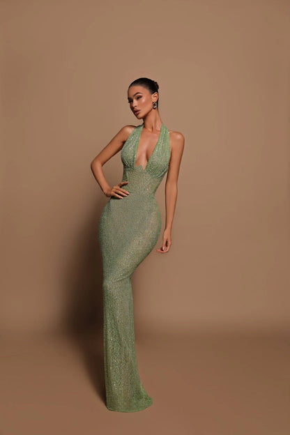 Women's green sequin halter maxi dress with plunging neckline and sleeveless fitted silhouette