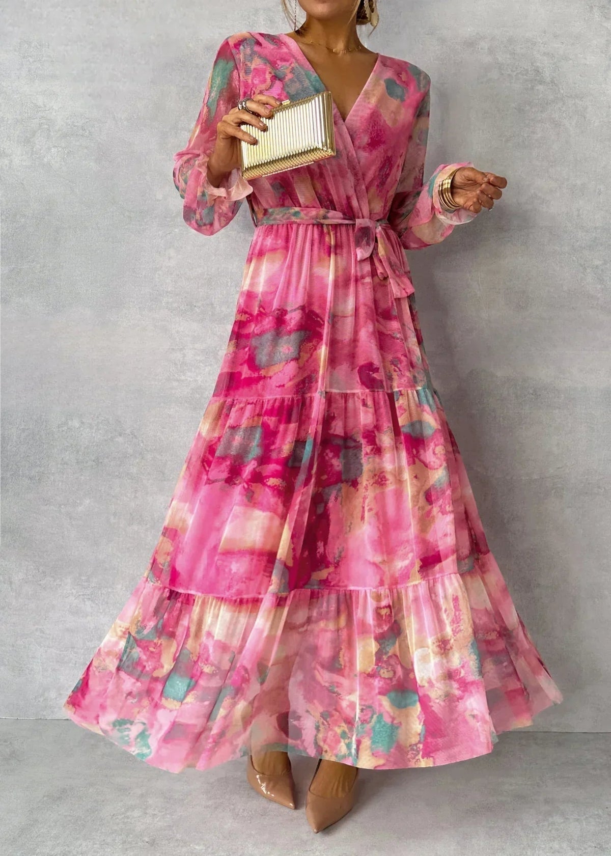 Women's pink floral wrap maxi dress with long sleeves and tiered skirt