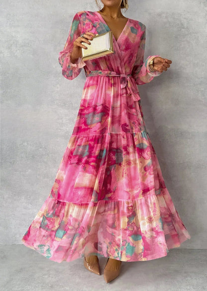 Women's pink floral wrap maxi dress with long sleeves and tiered skirt