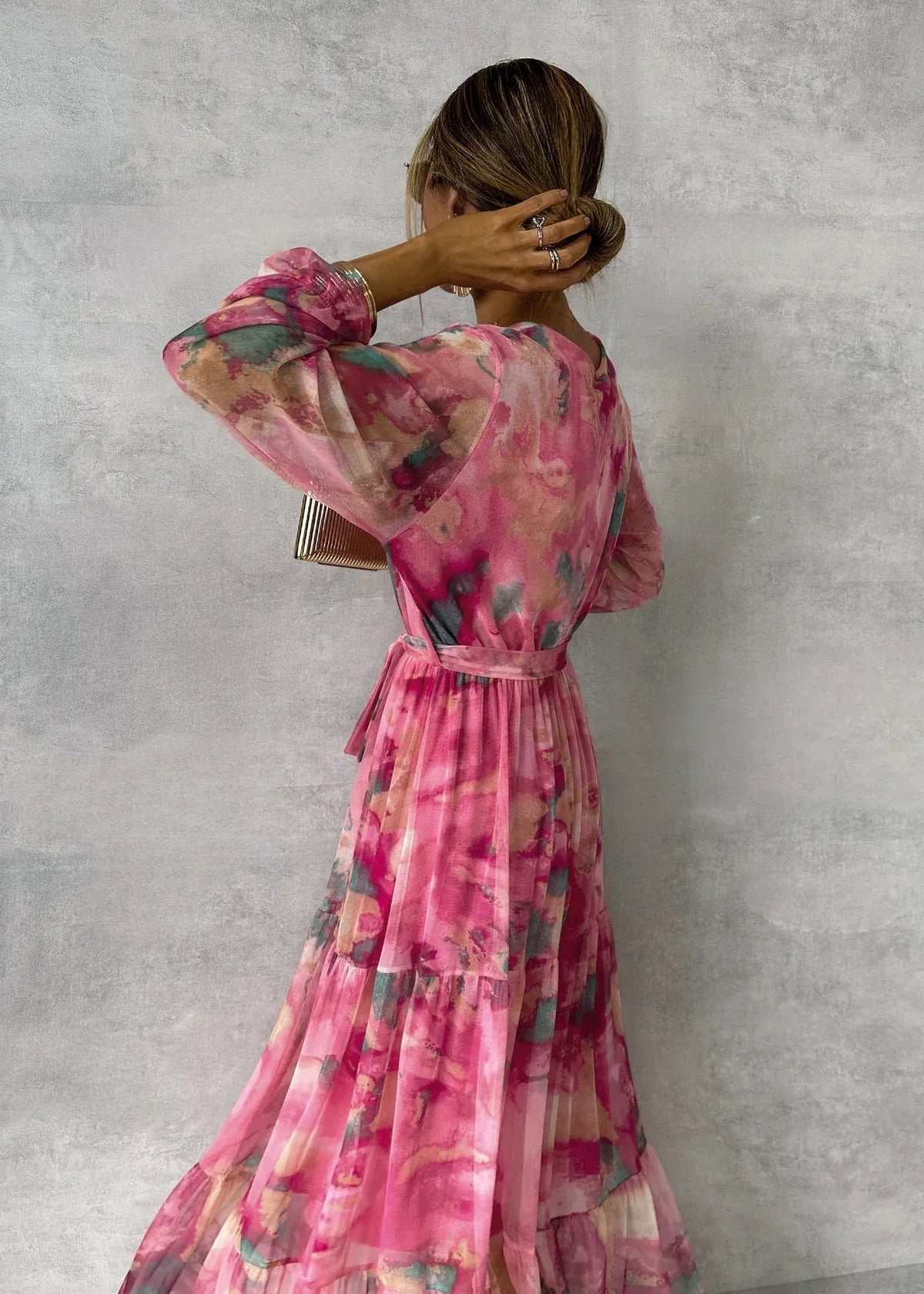 Women's pink floral wrap maxi dress with long sleeves and tiered skirt