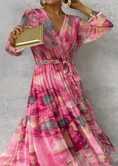 Women's pink floral wrap maxi dress with long sleeves and tiered skirt