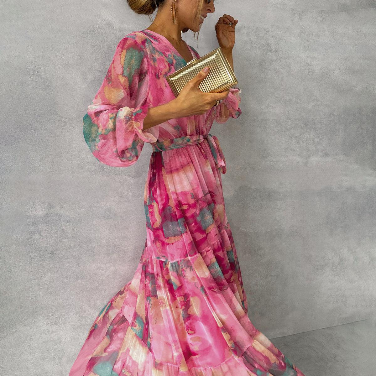 Women's pink floral wrap maxi dress with long sleeves and tiered skirt