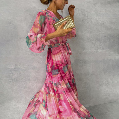 Women's pink floral wrap maxi dress with long sleeves and tiered skirt