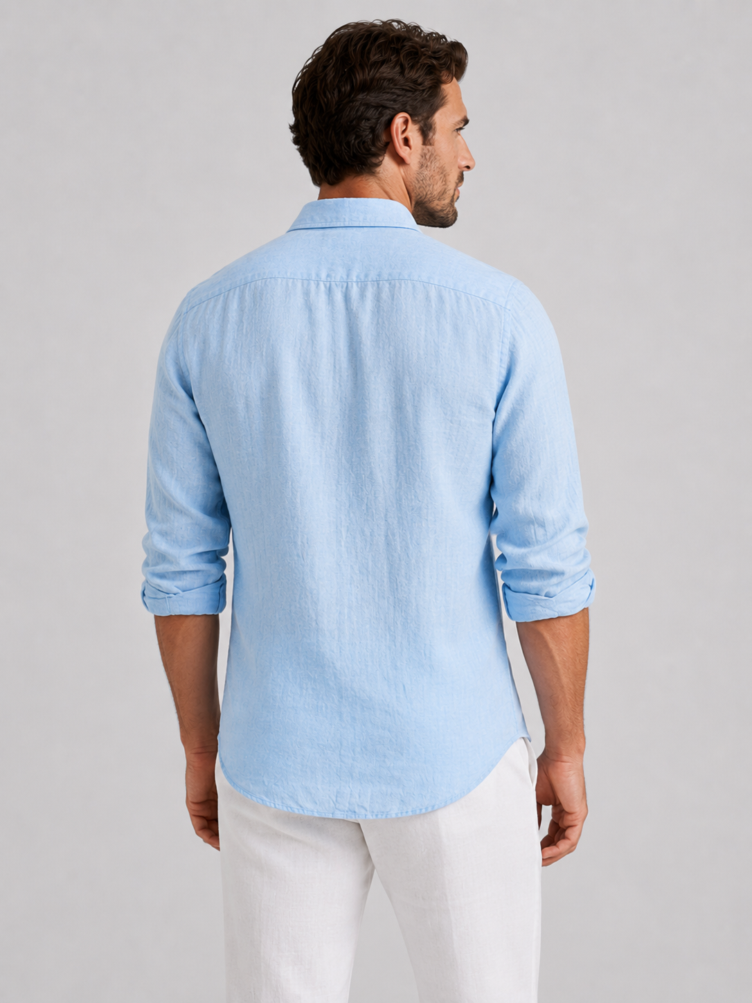 Men's long-sleeve textured button-up shirt with pointed collar and curved hem