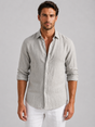 Men's long-sleeve textured button-up shirt with pointed collar and curved hem