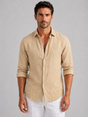 Men's long-sleeve textured button-up shirt with pointed collar and curved hem