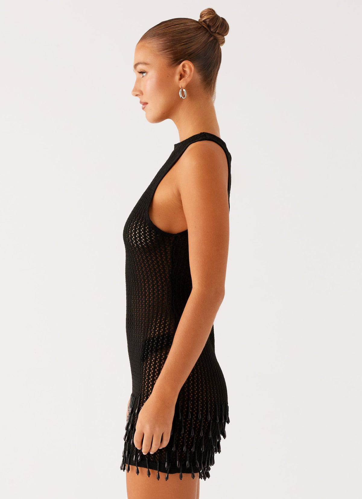 Women's black crochet mini dress with open back and beaded fringe hem