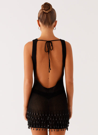 Women's black crochet mini dress with open back and beaded fringe hem