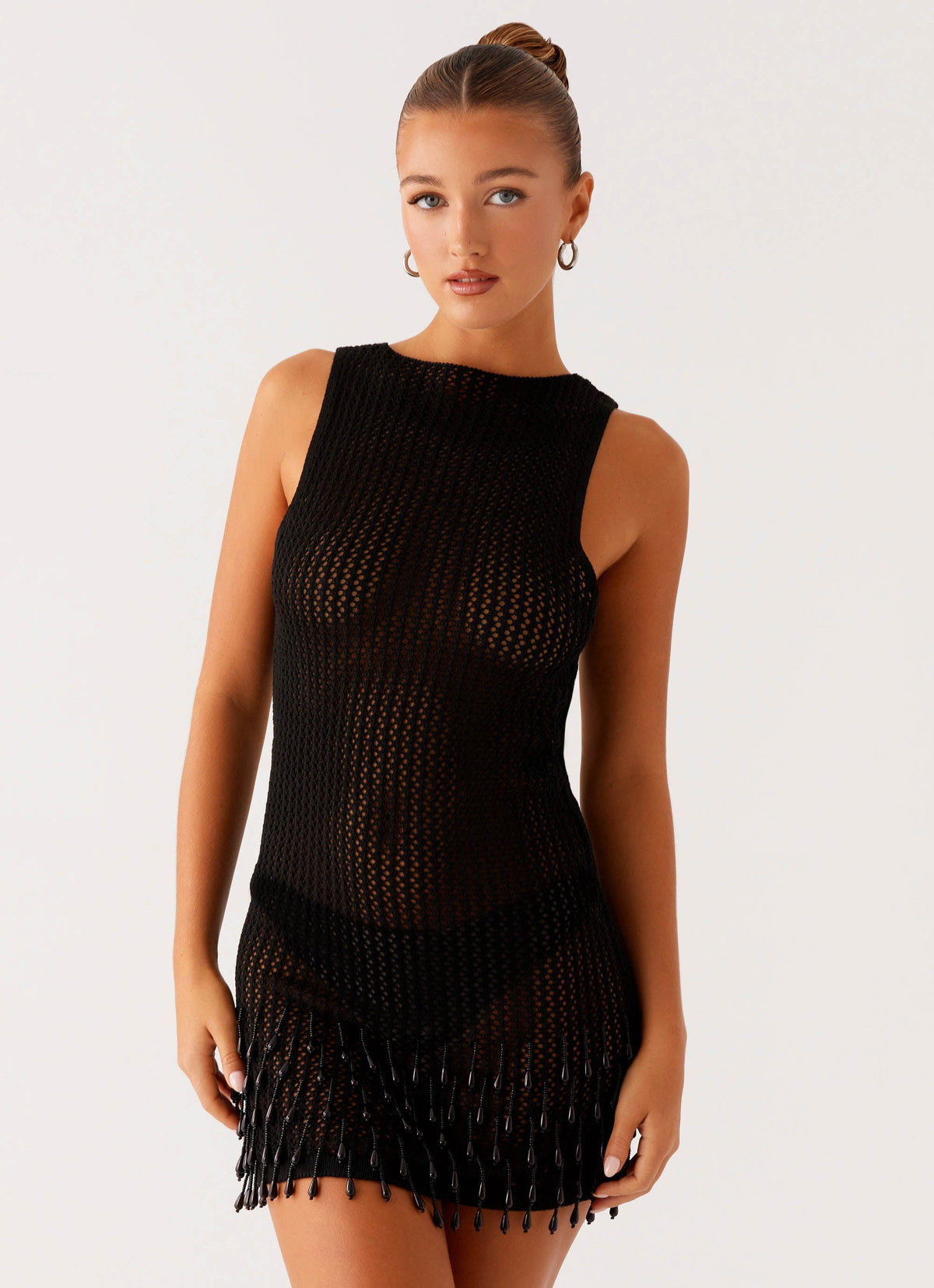 Women's black crochet mini dress with open back and beaded fringe hem