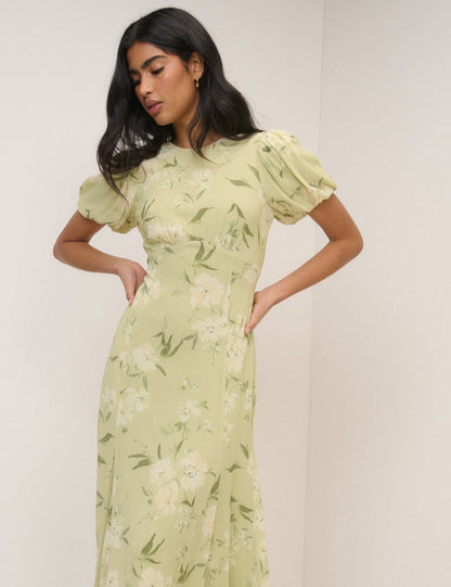 Women's pale green floral maxi dress with short puff sleeves and open back