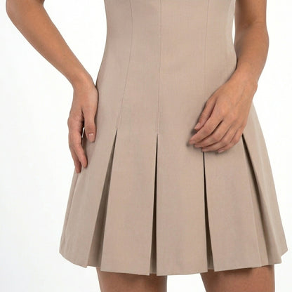 Women's sleeveless pleated mini dress with fitted bodice and flared skirt