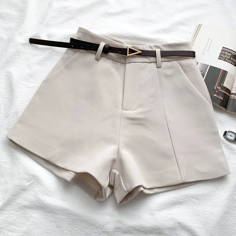 Women's high-waisted tailored shorts with a belt and triangular buckle