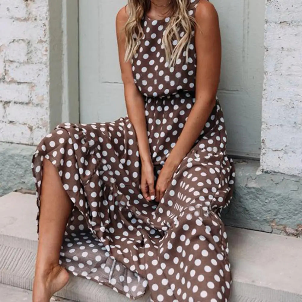 Women's sleeveless polka dot midi dress with a round neckline and flowing skirt