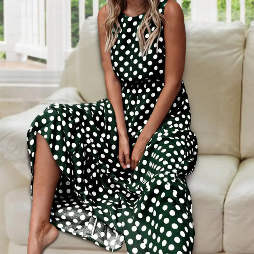 Women's sleeveless polka dot midi dress with a round neckline and flowing skirt