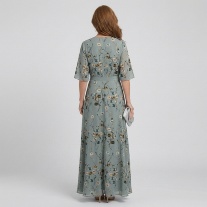 Women's green floral wrap maxi dress with V-neckline and elbow-length sleeves
