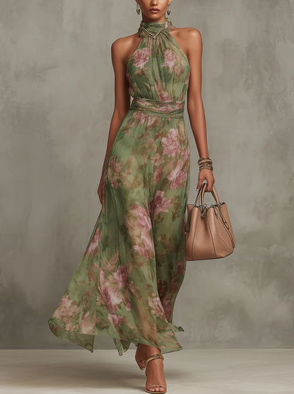 Women's green floral halter maxi dress with a defined waist and flowing skirt