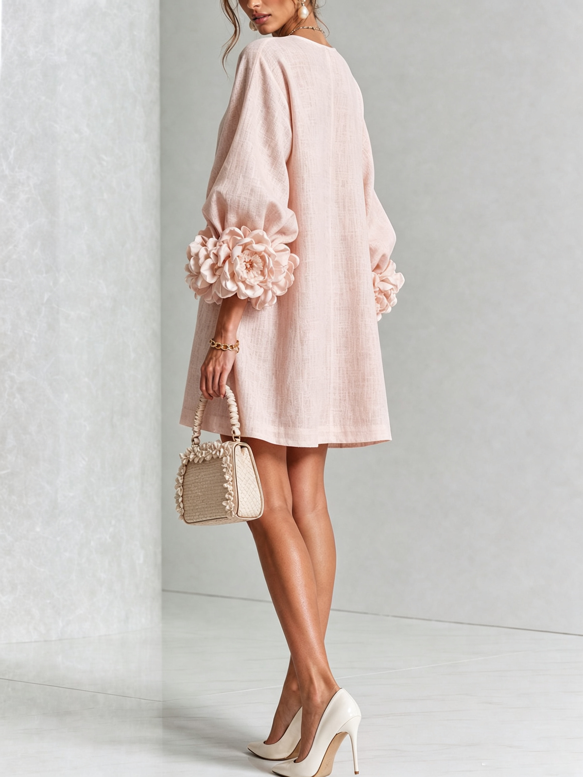 Women's pink mini dress with long sleeves, front buttons and large flower cuffs