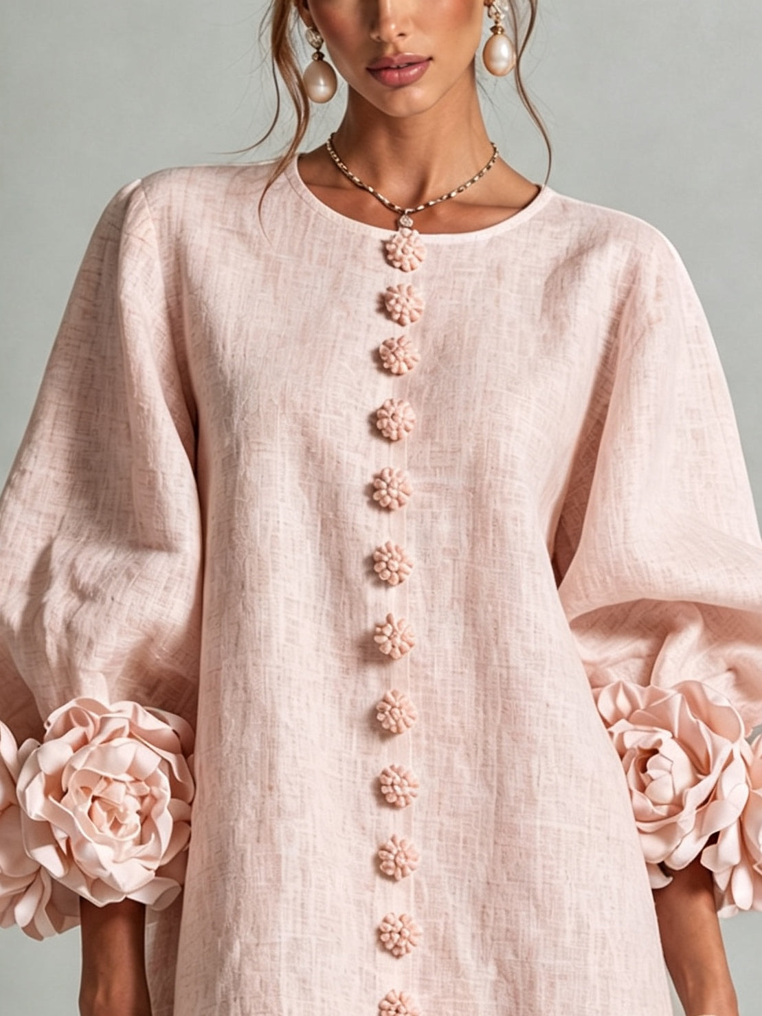 Women's pink mini dress with long sleeves, front buttons and large flower cuffs