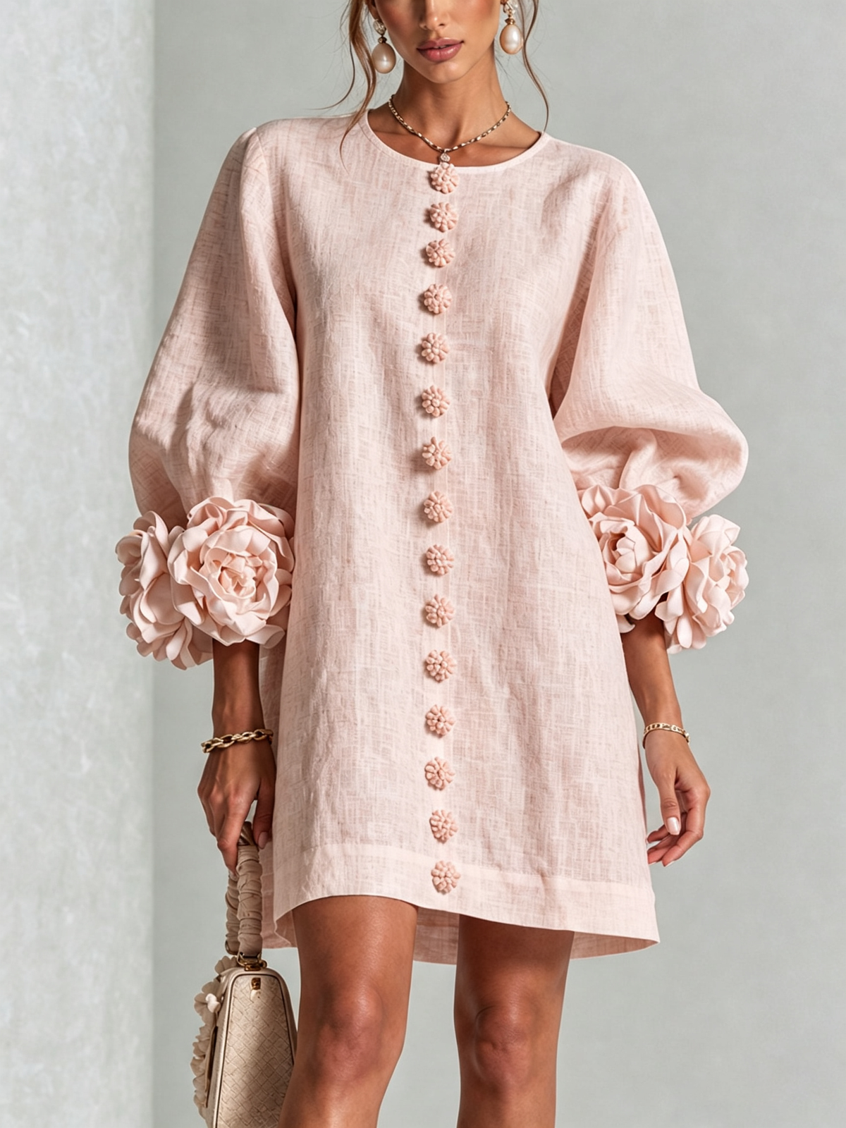 Women's pink mini dress with long sleeves, front buttons and large flower cuffs