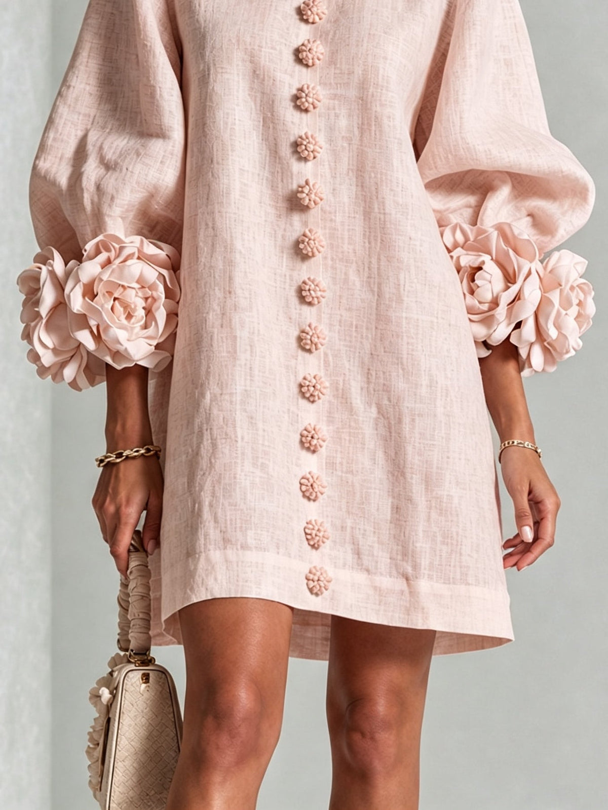 Women's pink mini dress with long sleeves, front buttons and large flower cuffs