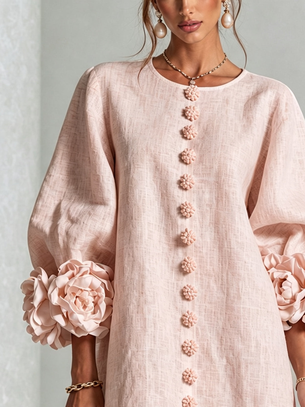 Women's pink mini dress with long sleeves, front buttons and large flower cuffs