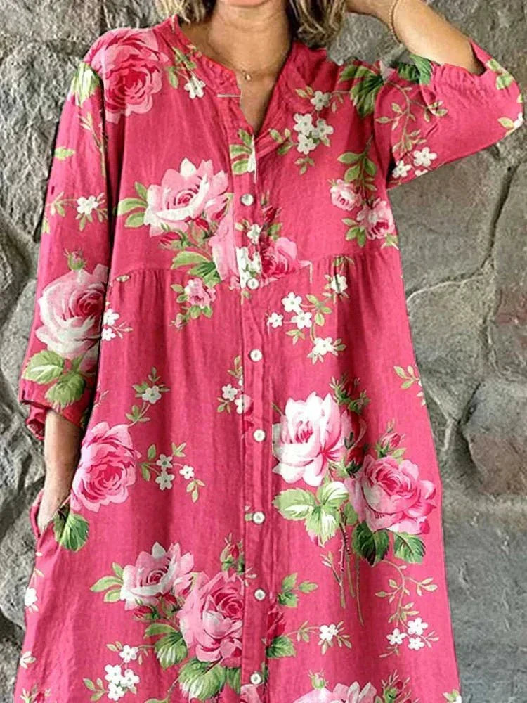 Women's pink floral button-front dress with V-neckline and 3/4 sleeves