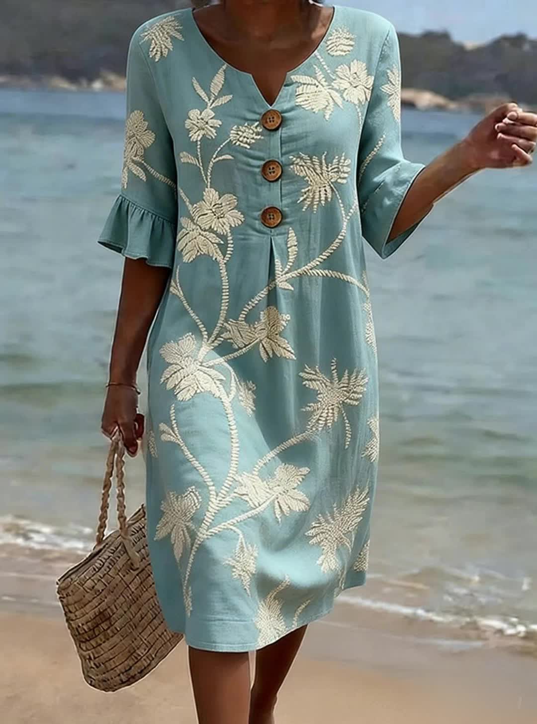 Blue knee-length floral dress with V-neckline, button front and three-quarter sleeves