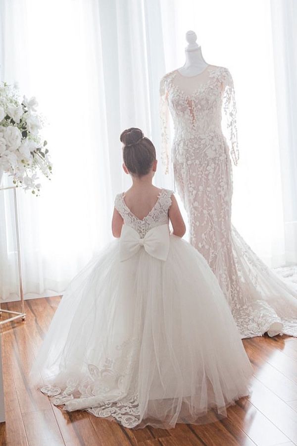 Ivory girls' lace ball gown dress with full tulle skirt, bow back and floral hem