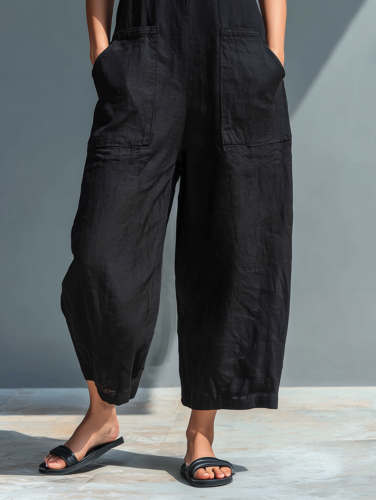 Women's sleeveless button-front utility jumpsuit with wide cropped legs and patch pockets