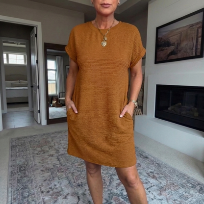 Women's textured short dress with crew neckline, short sleeves and side pockets