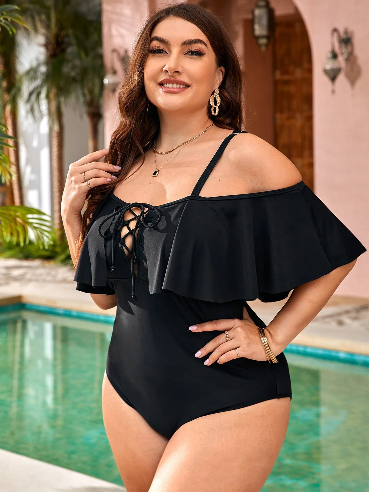 Women's plus size one-piece swimsuit with ruffle overlay and lace-up front