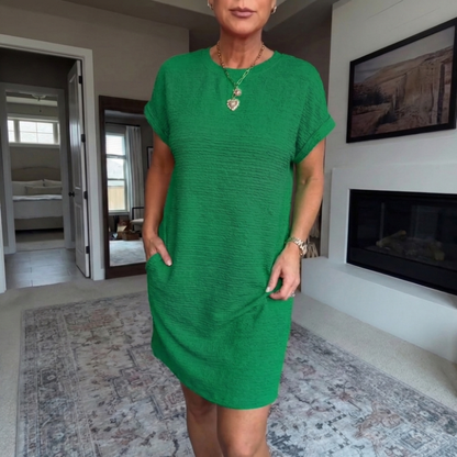 Women's textured short dress with crew neckline, short sleeves and side pockets