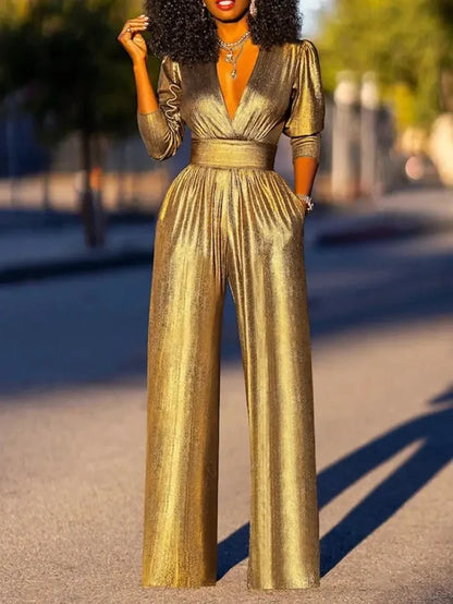 Woman wearing a shiny wide-leg jumpsuit with a deep V-neckline and three-quarter sleeves