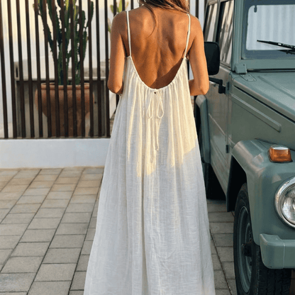 Women's flowing backless maxi dress with V-neckline and spaghetti straps