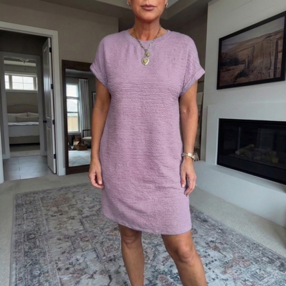 Women's textured short dress with crew neckline, short sleeves and side pockets