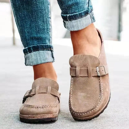 Women's mule sandals with round toes, side buckles and flat layered soles