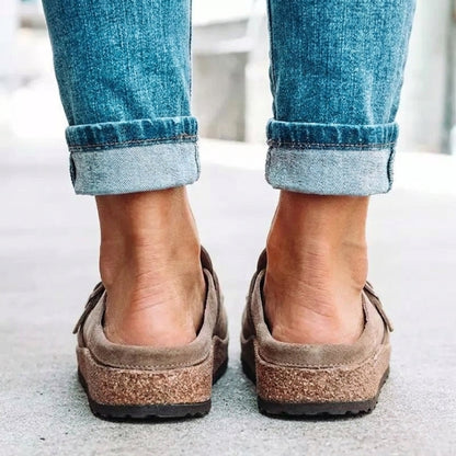 Women's mule sandals with round toes, side buckles and flat layered soles